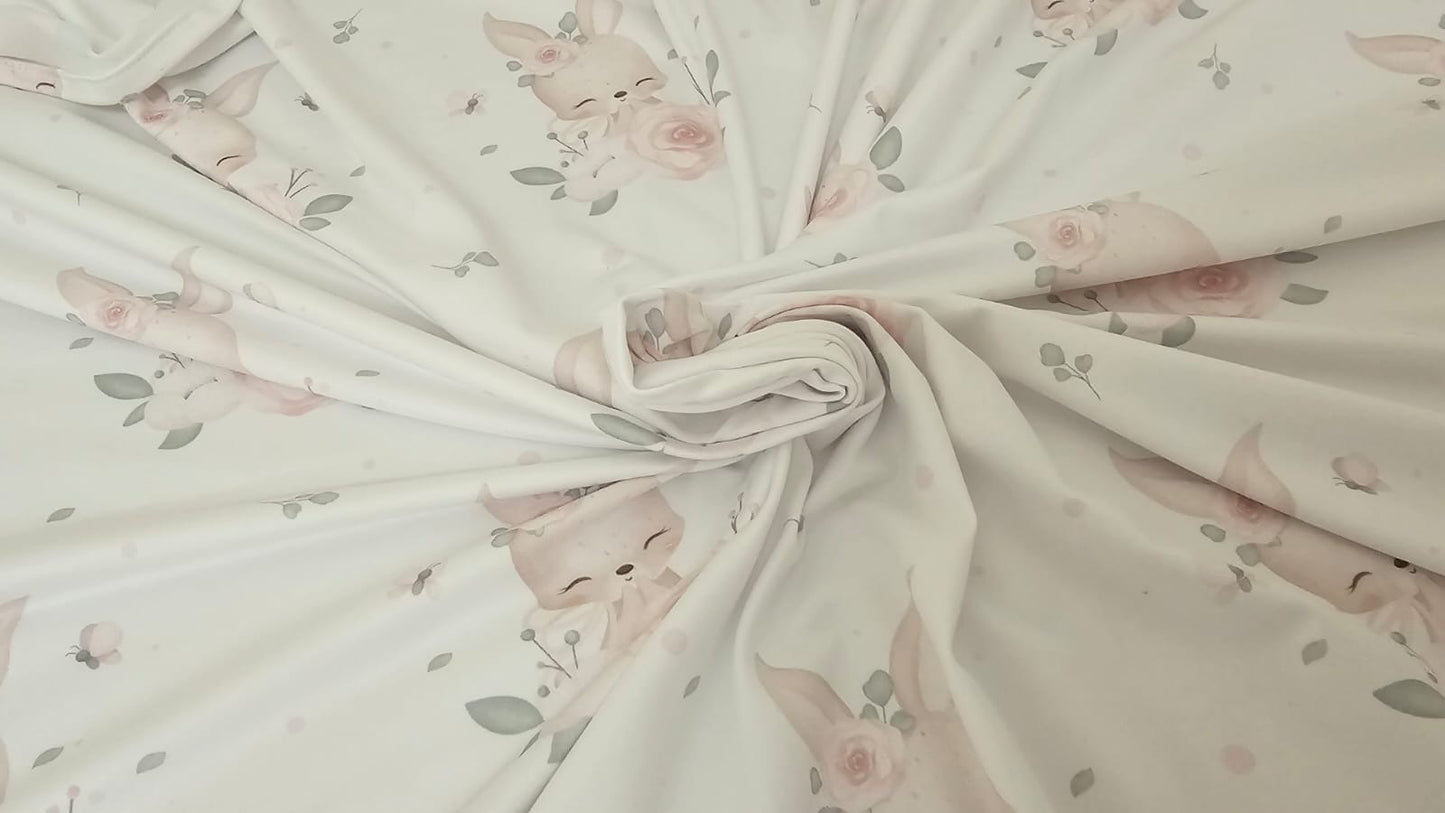 Fabric with pink floral and bunny pattern on a light background