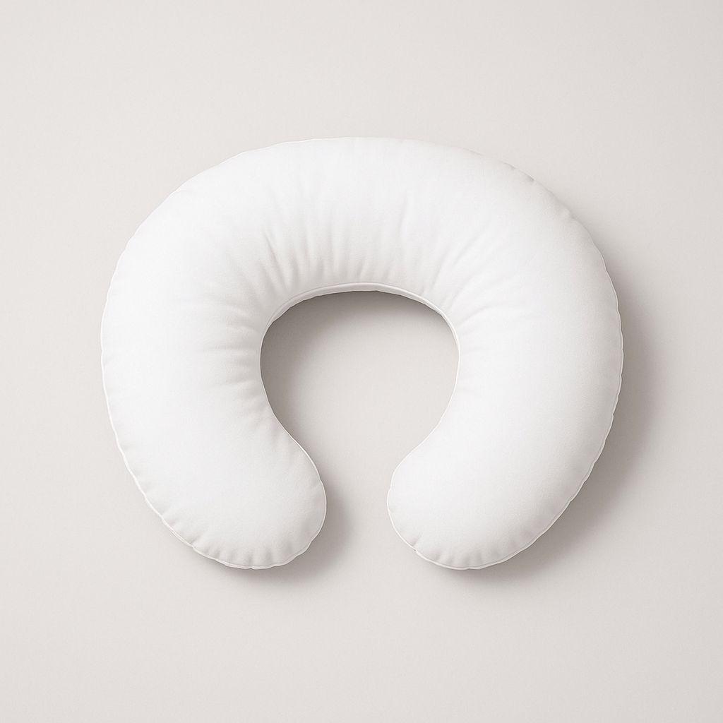 White U-shaped feeding pillow on a light gray background