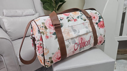 Floral-patterned duffel bag with 'Ancel' branding on a white surface.