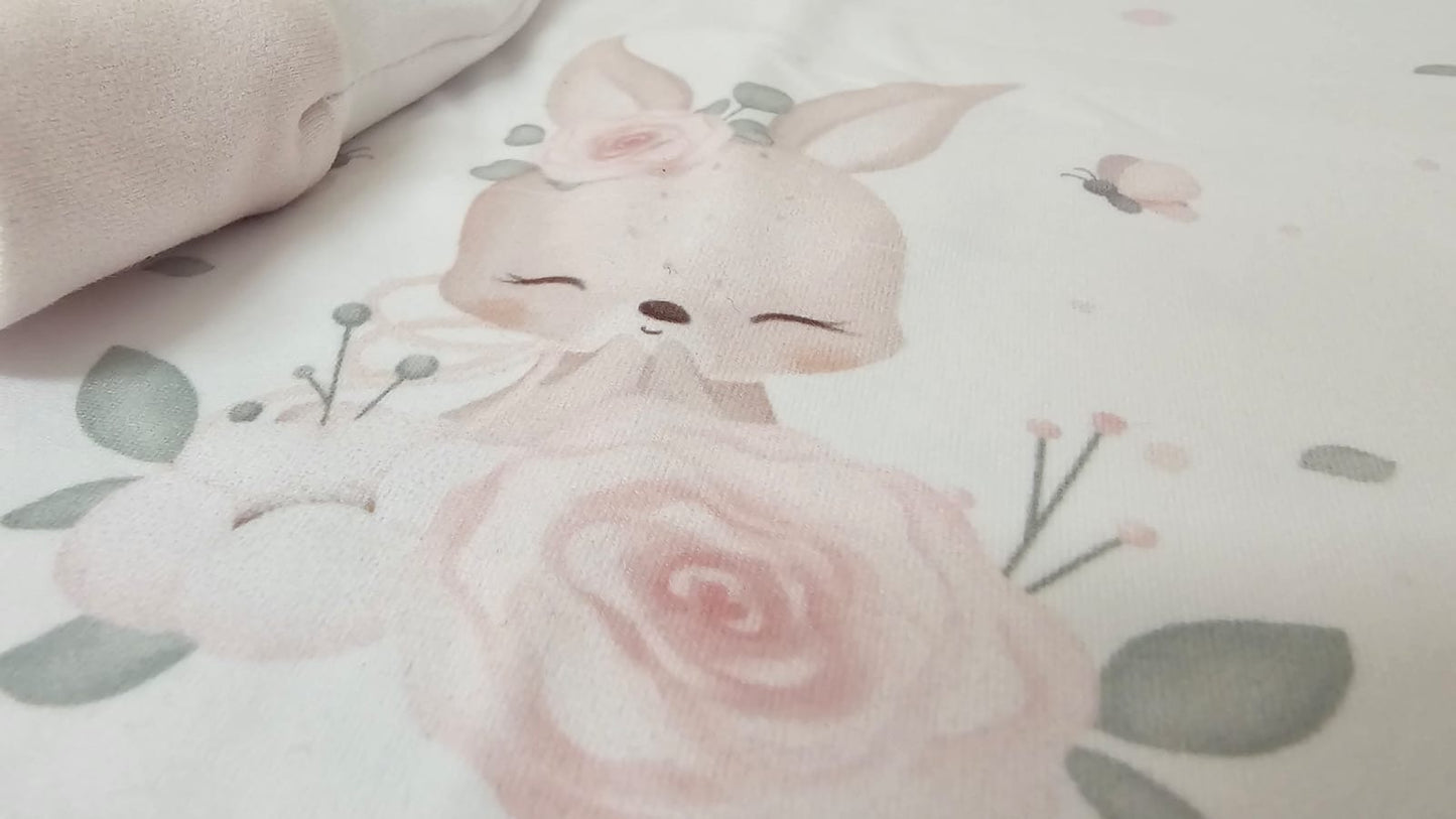 Cute cartoon bunny with a bow surrounded by pink roses and green leaves on a light background