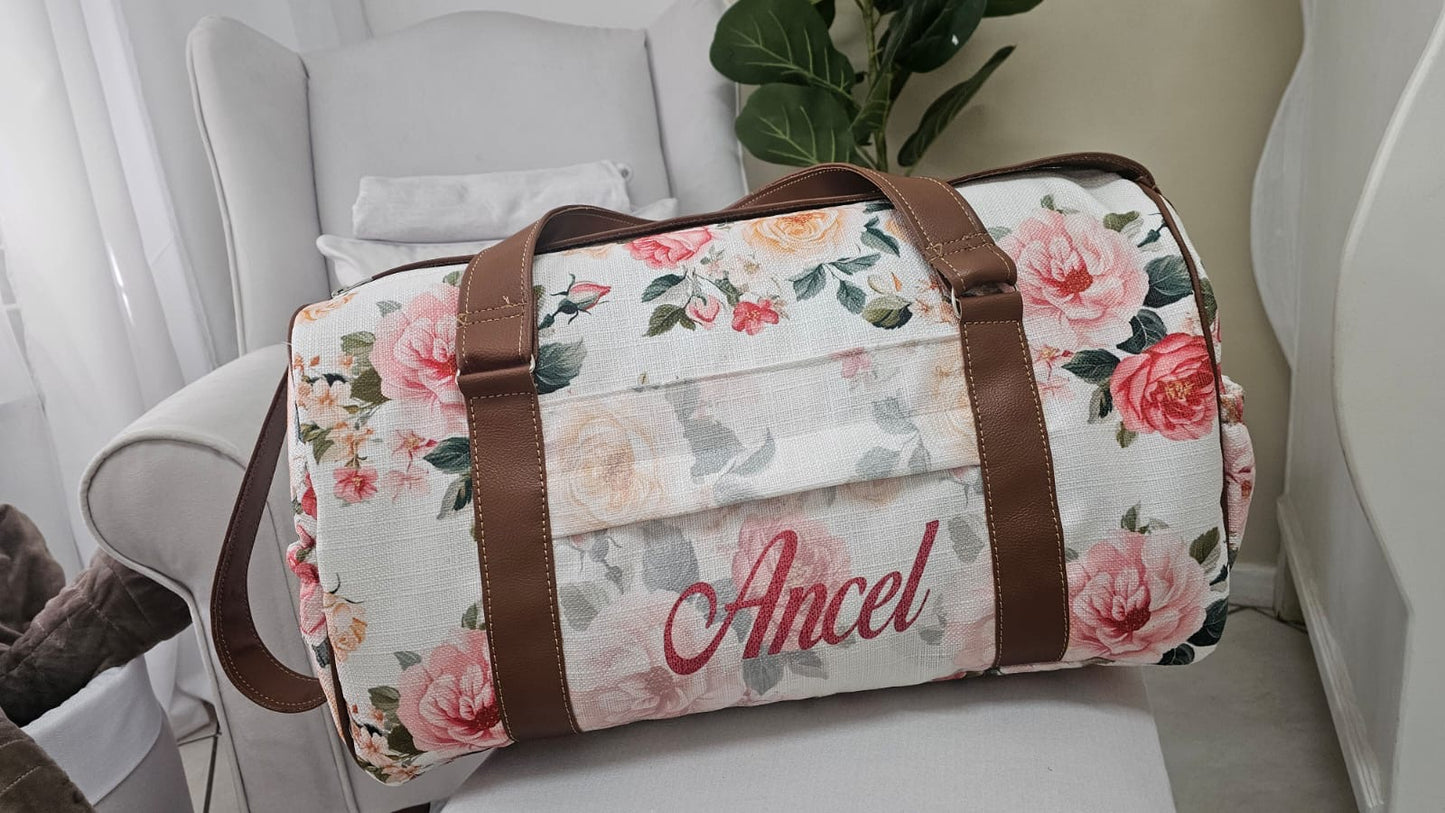 Floral-patterned duffel bag with 'Ancel' branding on a white surface.