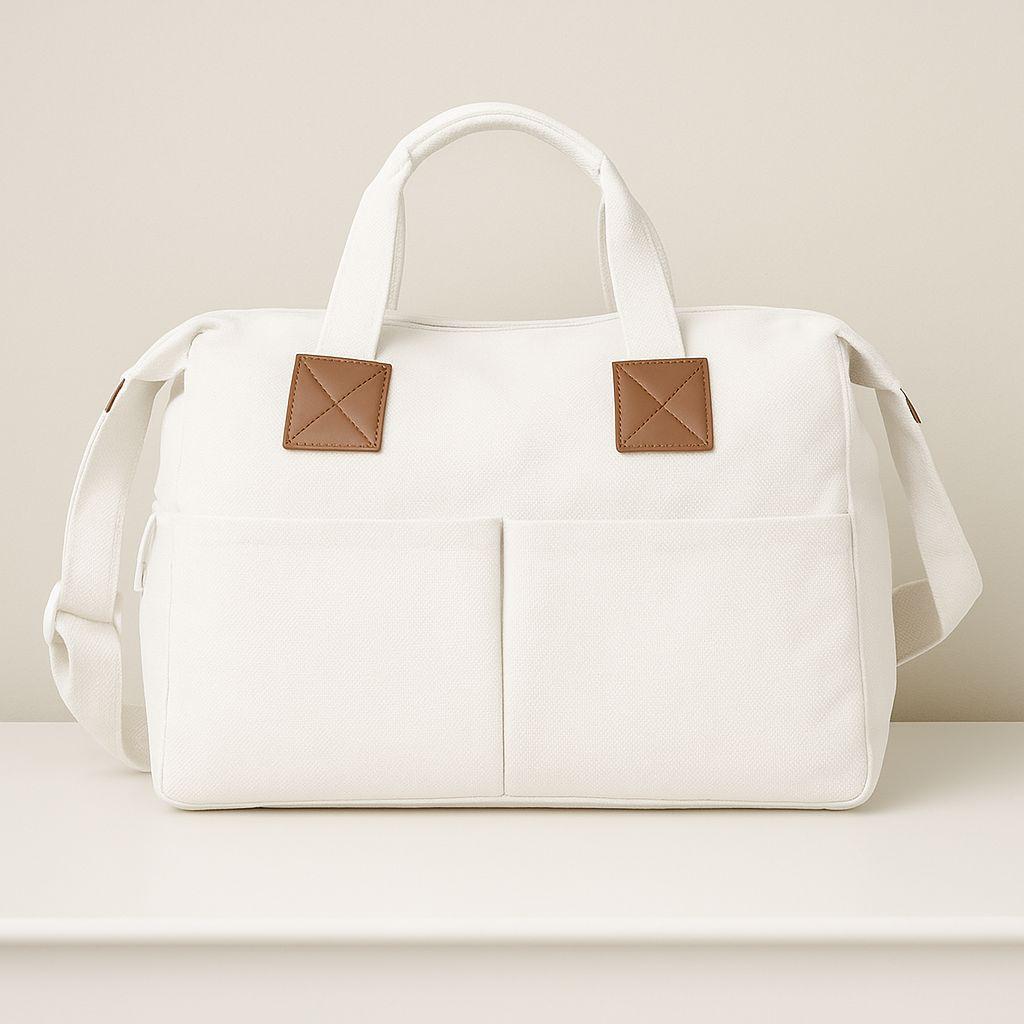 White Nappy bag with brown patches on a light beige background