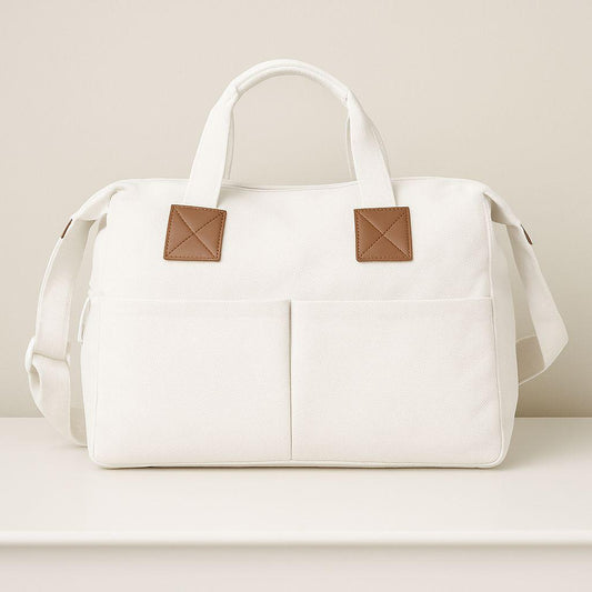 White Nappy bag with brown patches on a light beige background