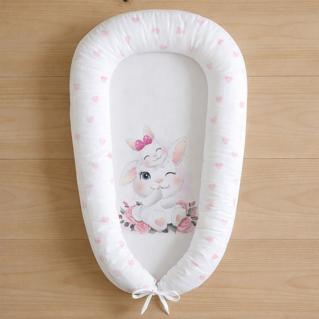 Bunny Love baby nest with pink heart print and cute bunny illustration on white background