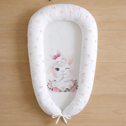 Bunny Love baby nest with pink heart print and cute bunny illustration on white background