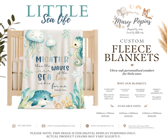 Custom fleece blanket with sea-themed design in a crib, featuring text and illustrations of marine life.
