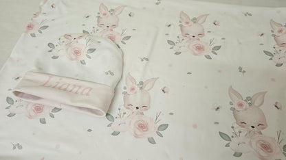 Baby blanket with floral and bunny designs on a matching towel.