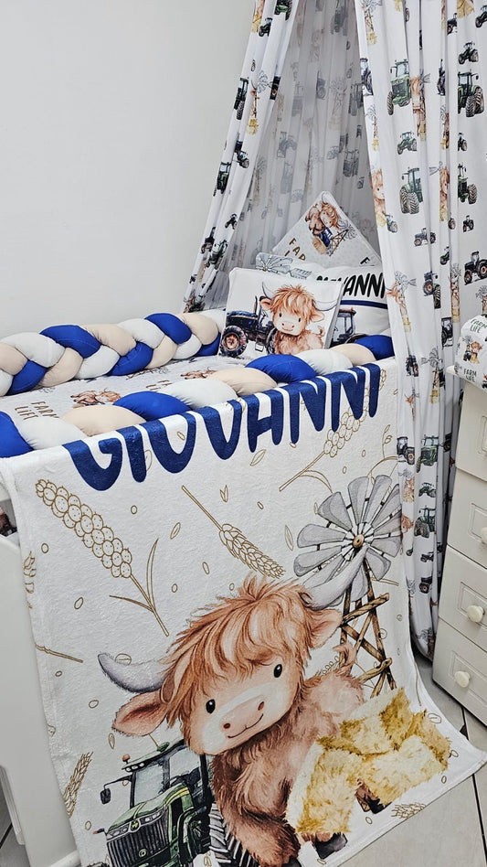 Children's room with a crib and decorative elements featuring a name and cartoon cow design.