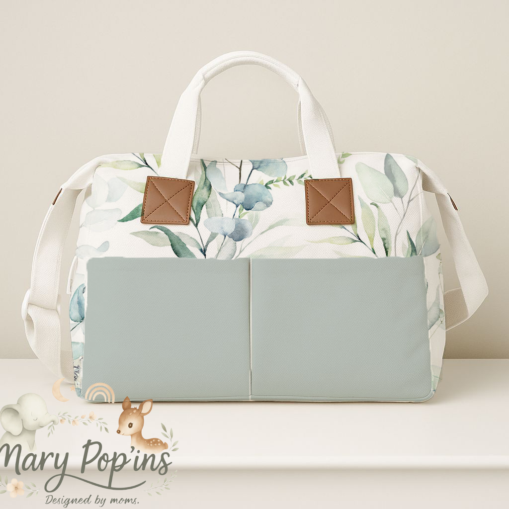Eucalyptus nappy bag featuring a soft sage and green leafy print with large front pockets, cream handles and tan trim in a calm neutral style | Eucalyptus doeksak met ’n sagte salie- en groen blaarpatroon, groot voorsakke, roomkleurige handvatsels en bruin afwerking in ’n rustige neutrale styl.