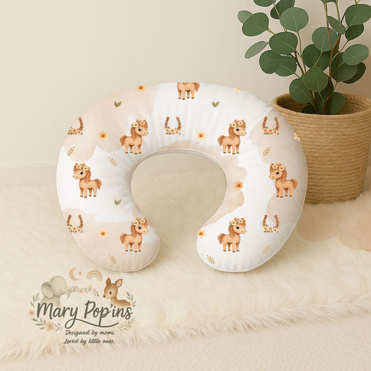 Horsey Blossom nursing pillow featuring sweet little horses, floral crowns, horseshoes and soft peach floral details on a white background | Horsey Blossom voedingskussing met oulike perdjies, blomkrone, hoefysters en sagte perskekleurige blomdetail op ’n wit agtergrond.