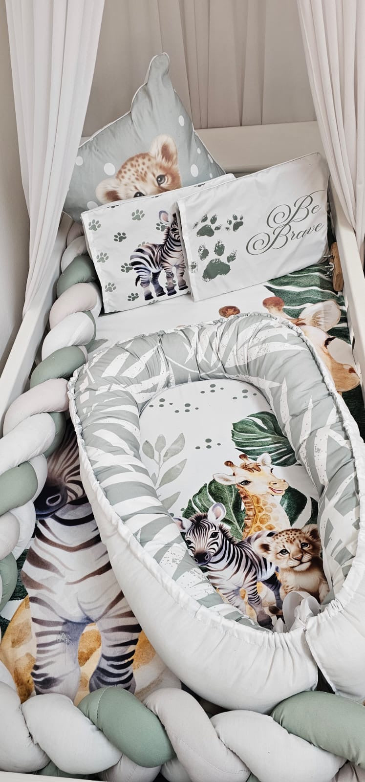 Children's room with a canopy bed, pillows, and stuffed animals.