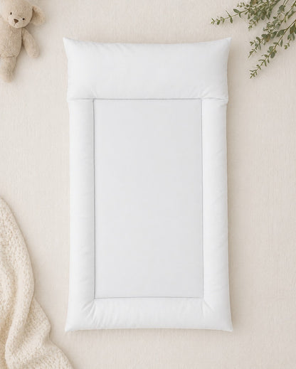 Soft white padded baby changing mat with raised cushioned sides, designed for comfortable nappy changes and everyday baby care | Sagte wit opgestopte baba-versorgingsmat met verhoogde sagte kante, ontwerp vir gemaklike doekruil en alledaagse babaversorging.
